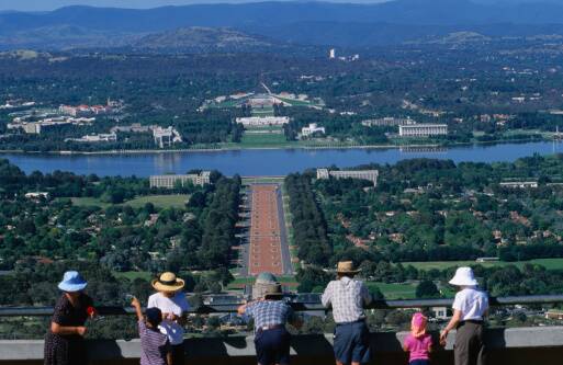 Tourists enjoying a view of Canberra, with Anzac Parade leading up to Lake Burley Griffin and Capital Hill (on top of which is Parliament House). Getty images