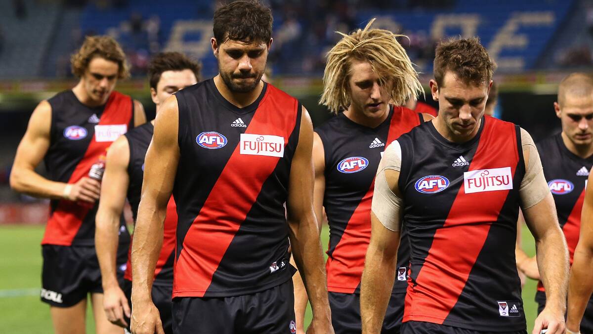 The Bombers look dejected after losing the round five AFL match between the Essendon Bombers and the St Kilda Saints at Etihad Stadium on April 19, 2014 in Melbourne, Australia. Photo: Quinn Rooney/Getty Images.