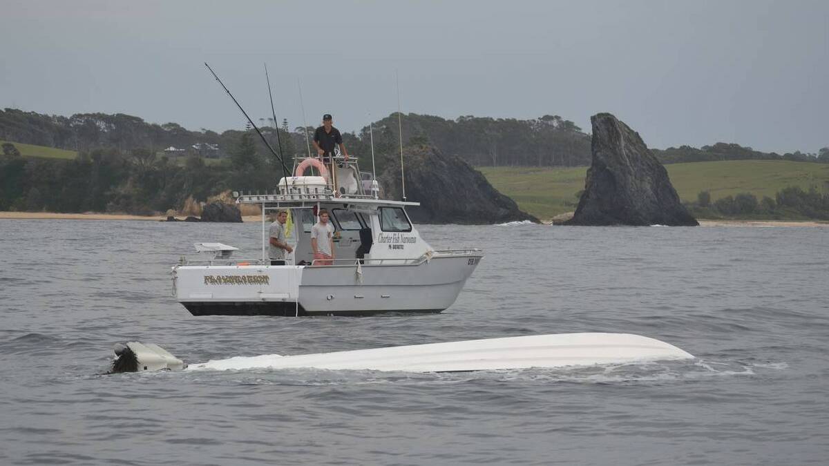 NAROOMA: The Charter Fish Narooma boat Nitro comes to the rescue on Thursday recovering the upturned fishing boat that flipped on the Narooma bar crossing on Wednesday