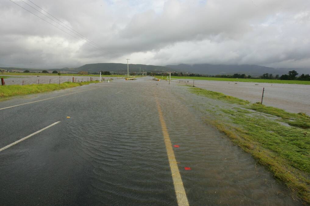 In June 2007 floodwaters ran over the Illawarra Highway at Albion Park again. Picture: ROBERT PEET