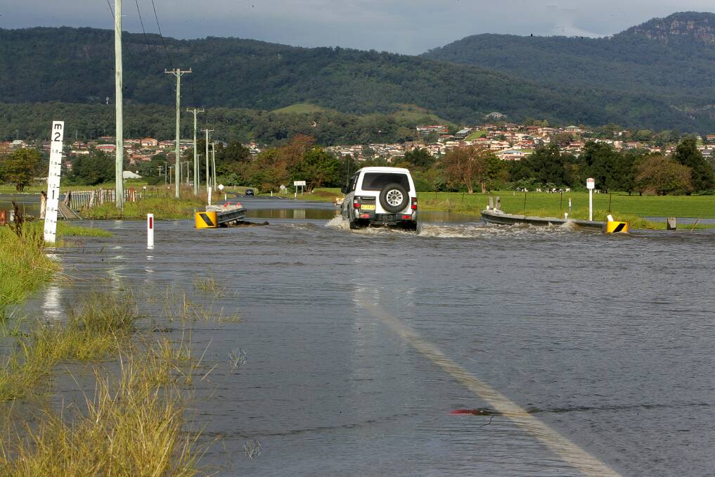 In June 2007 floodwaters ran over the Illawarra Highway at Albion Park again.  Picture: SYLVIA LIBER
