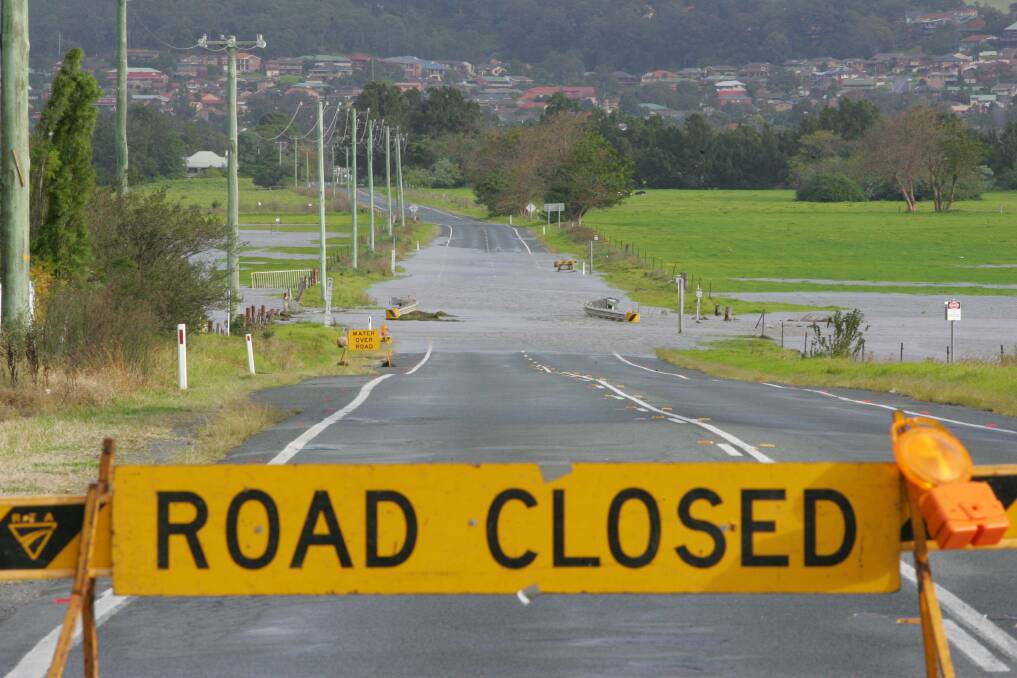 In June 2007 floodwaters ran over the Illawarra Highway at Albion Park and saw the road closed again. Picture: ROBERT PEET