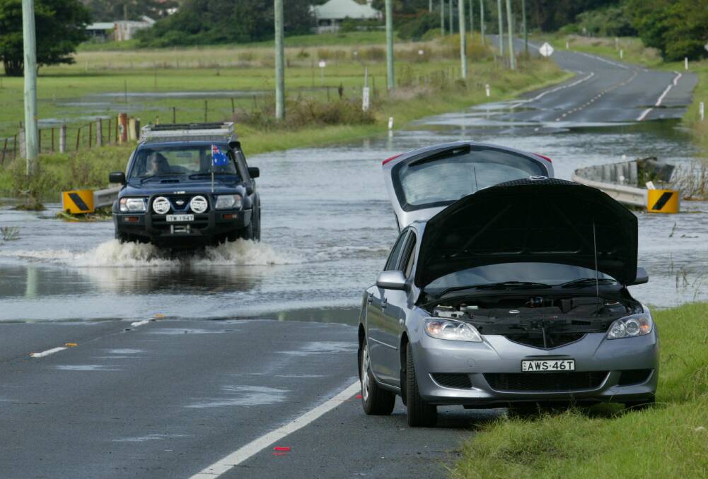 A car sits damaged after it tried to cross floodwaters on the Illawarra Highway in February 2007. Picture: DAVID TEASE