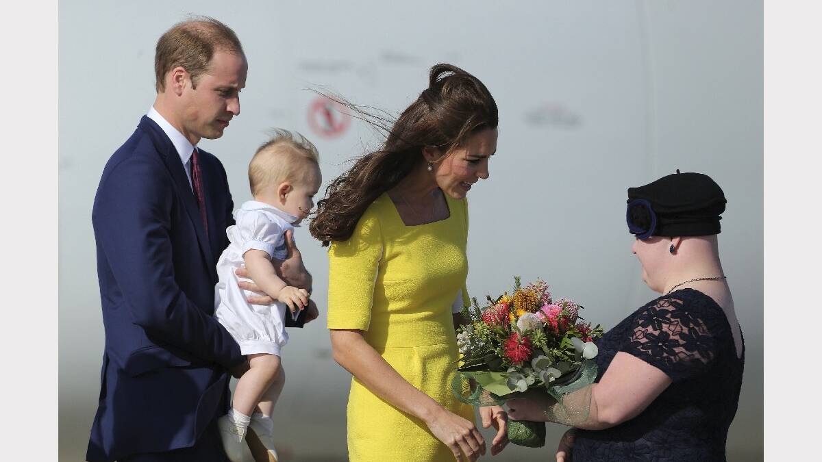 NOWRA: Her Royal Highness, Catherine Duchess of Cambridge receives flowers from Joscelyn Sweeney, with His Royal Highness Prince William, Duke of Cambridge holding Prince George on arriving at Sydney Airport. Photo: KATE GERAGHTY