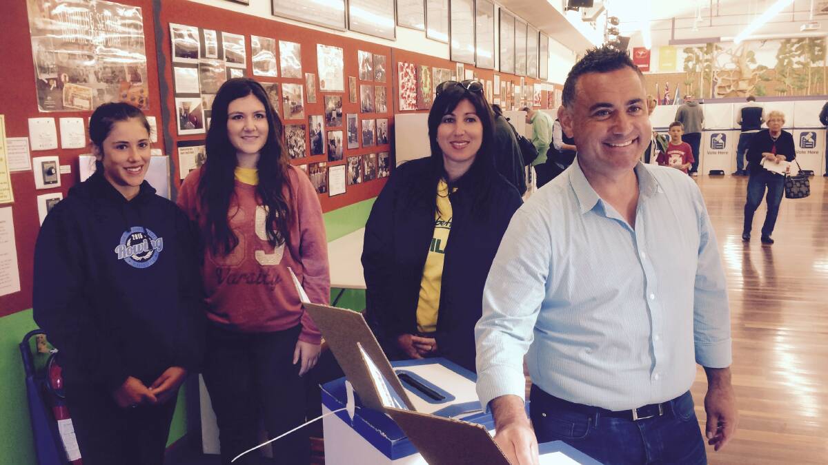 John Barilaro MP casts his vote at Jerrabomberra Public School on Saturday with wife Deanna and daughters Alessia and Domenica. 