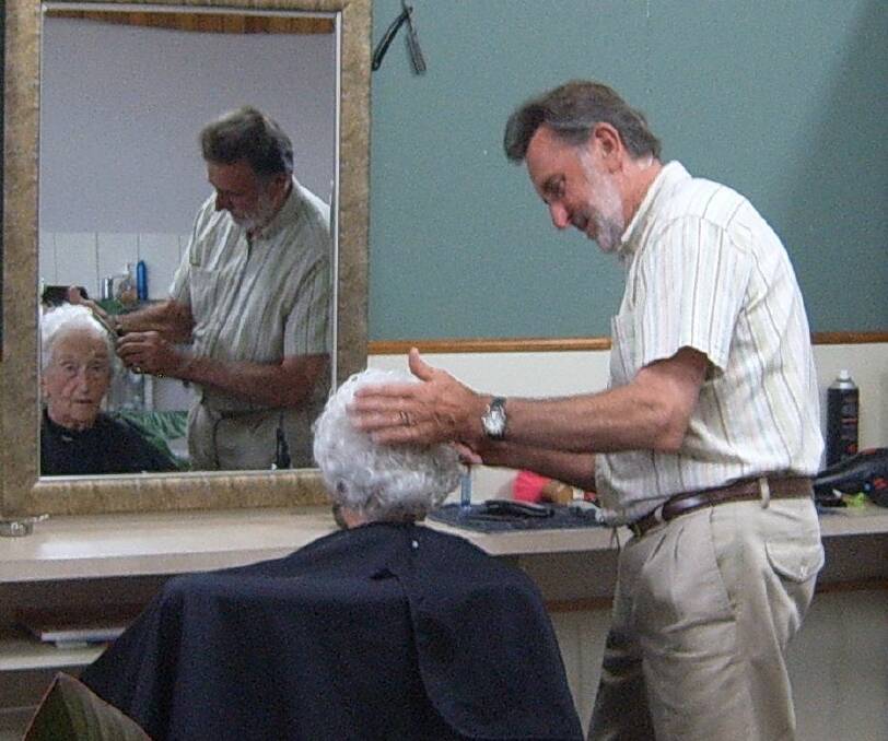 Dick Robinson cutting Grace Epplestun’s hair on her 100th birthday.