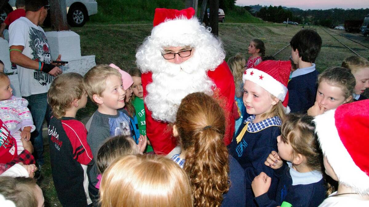 Friends of the Bombala Railway hosted Carols by Candlelight on November 29, with a big crowd gathering to enjoy the sing along, the stalls, the ham raffles and Santa's arrival with a police escort.