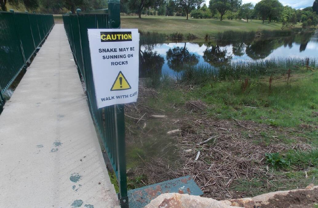 A local resident has put up a sign warning others to take care around the bottom footbridge where a snake can regular be found sunning itself. 
