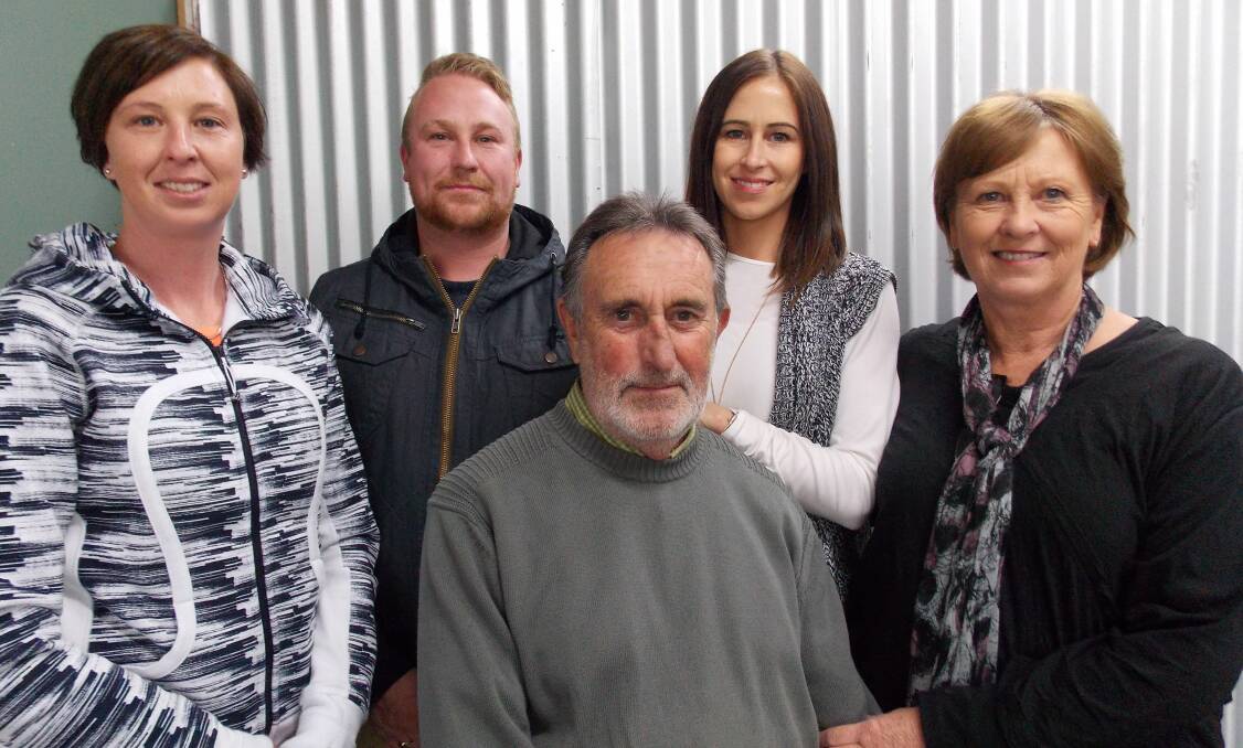 Dick Robinson and his family on his last day of hairdressing in Bombala