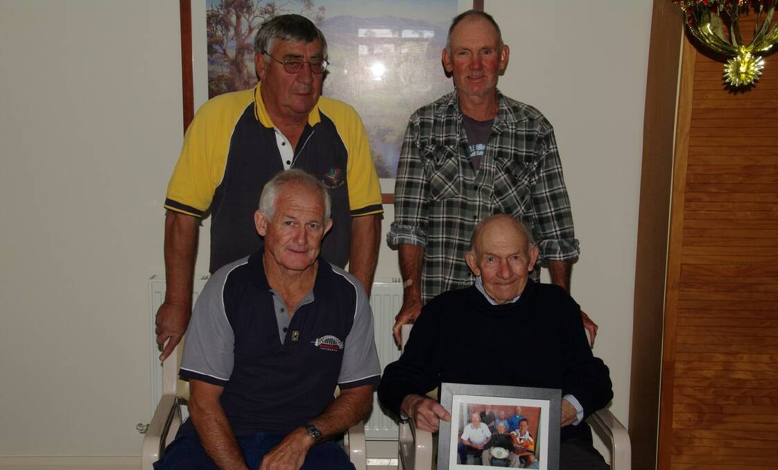 Don Stewart (front right) was presented with a framed photograph and thanked for his support of local football over the years by the Men of League Foundation’s John Ratcliffe, Tim Stewart and Colin Ryan.

