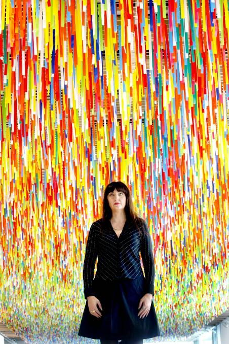 Artist Nike Savvas with her new work "Rally" which is made up of 60,000 strips of custom-sewn plastic bunting and is 60 metres by 8 metres making it one of the largest works exhibited at the Art Gallery of NSW. Photo: Steven Siewert