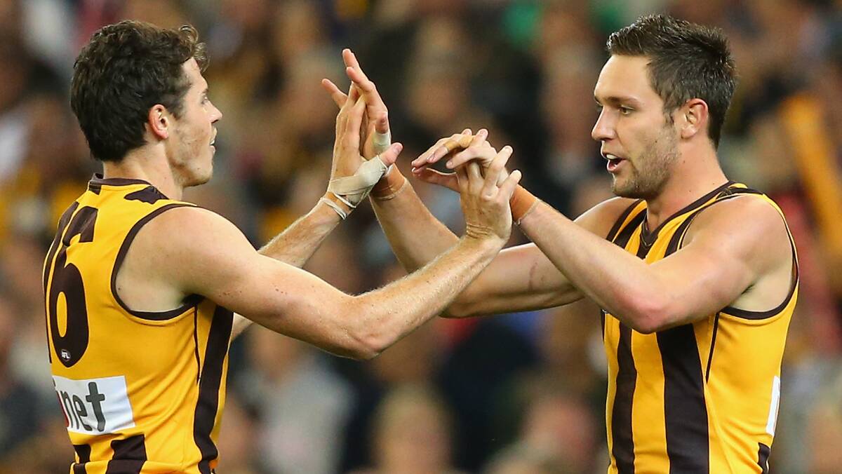 Isaac Smith and Jack Gunston of the Hawks celebrate a goal . The Hawks defeated the visiting Dockers 137-79. Picture: Getty Images