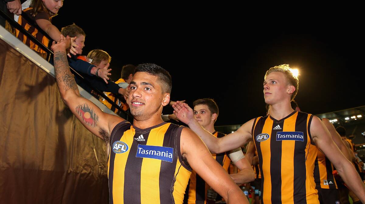 Bradley Hill and Will Langford of the Hawks high five fans after winning. The Hawks defeated the visiting Dockers 137-79. Picture: Getty Images