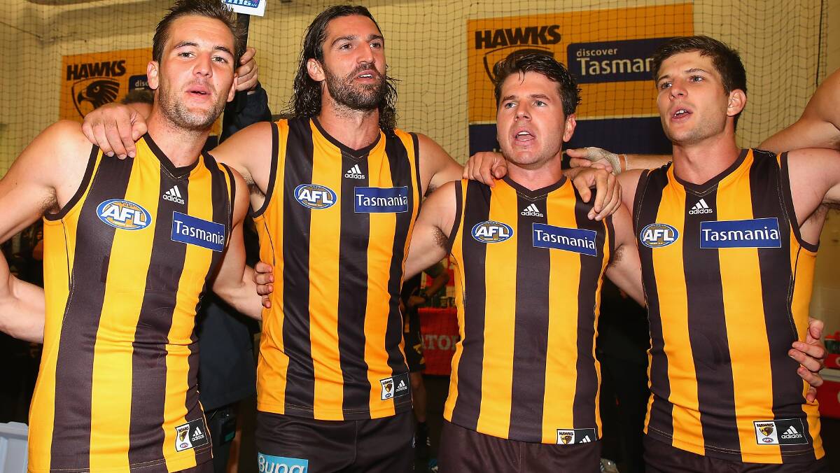 Matt Suckling, Matt Spangher, Jonathan Simpkin and Luke Breust of the Hawks sing the song in the rooms after winning. The Hawks defeated the visiting Dockers 137-79. Picture: Getty Images