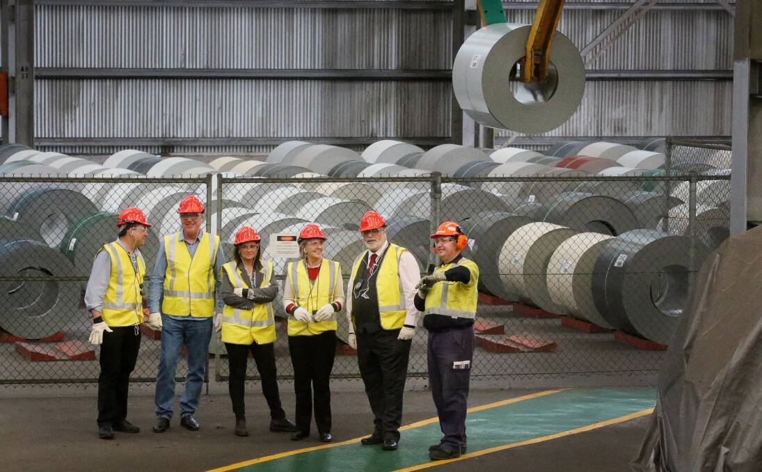 STEEL STRATEGY: Labor's spokesman for innovation and industry Kim Carr (second from right) visits BlueScope's Port Kembla steelworks last month. Senator Carr says "we can't afford to let the steel industry die". Picture: Robert Peet