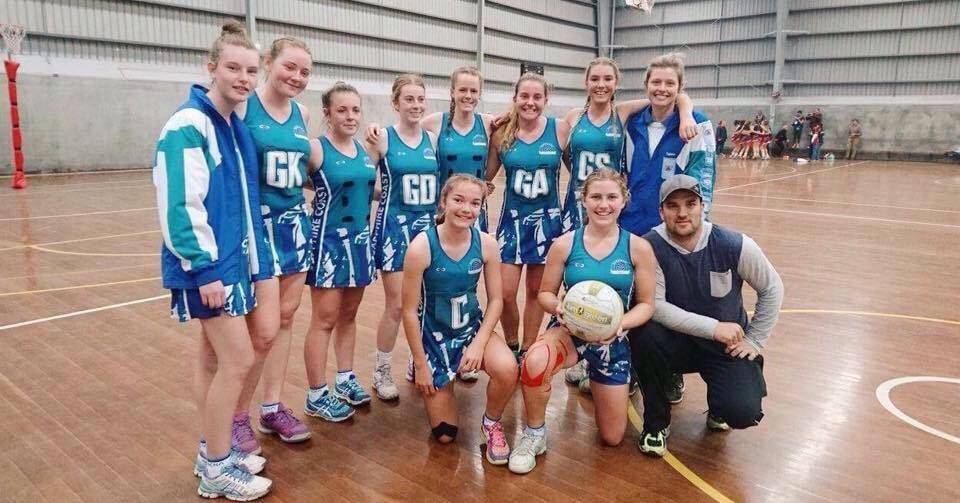 Great result: The Sapphire Coast under 15 netball team with coaches Tyjana Thelan and Adam Blacka celebrate after finishing fifth in the State Championships recently. 