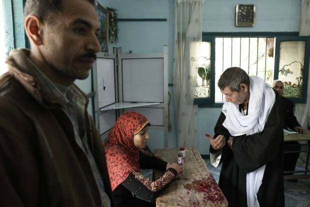 An Egyptian man inks his finger after casting her vote at a polling booth Photo: Ed Giles/Getty Images