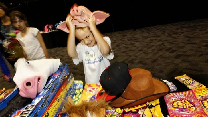 Ryan Mackandev, aged 7, tries out showbags during a Royal Easter Show preview. Photo: Steven Siewert SWS