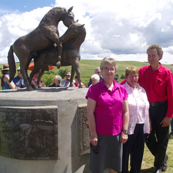 Delegate Progress Association member and coordinator of the sculpture project, Doreen Standen, with Rix Wright’s wife, Jenny and son, Rowan in front of the impressive and newly unveiled wild horses piece.