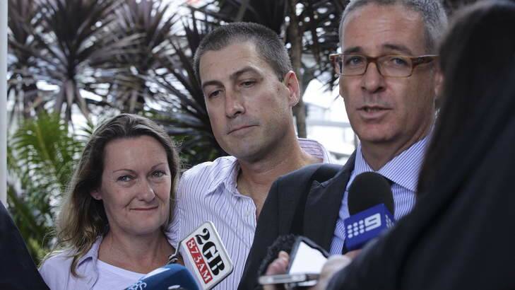 Back home: Marcus and Julie Lee, with their lawyer John Sneddon at Sydney Airport. Photo: Kate Geraghty