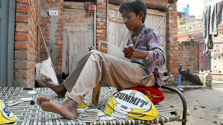 Pittance: Ramandeep, 13, earns about $1.20 a day stitching Summit balls bound for sale in Australia. Photo: Ben Doherty
