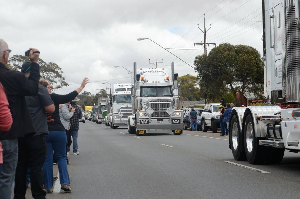 People line the streets to watch as the trucks roll into Murray Bridge for the opening of the White Hill Truck Drivers Memorial.