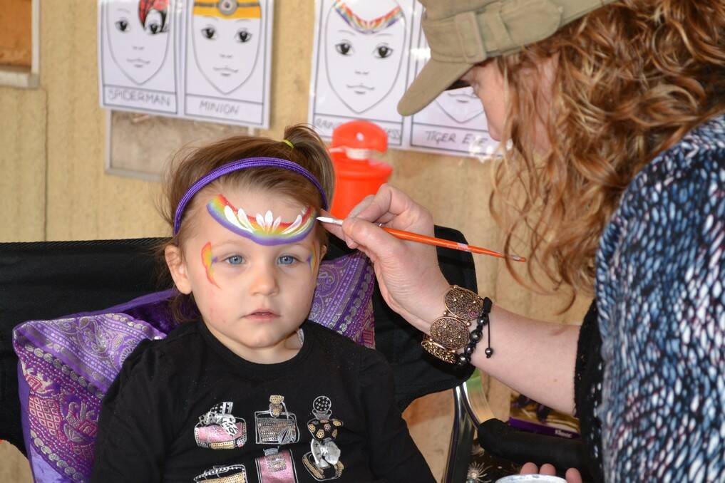 Mia Schubert gets her face painted by Lisa Johns at the Murray Bridge Racing Course on Sunday as part of the White Hill Truck Drivers Memorial Remembrance Truck Show festivities.