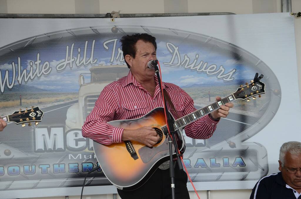Singer Graham Rogers takes to the stage during the opening of the White Hill Truck Drivers Memorial at Murray Bridge.