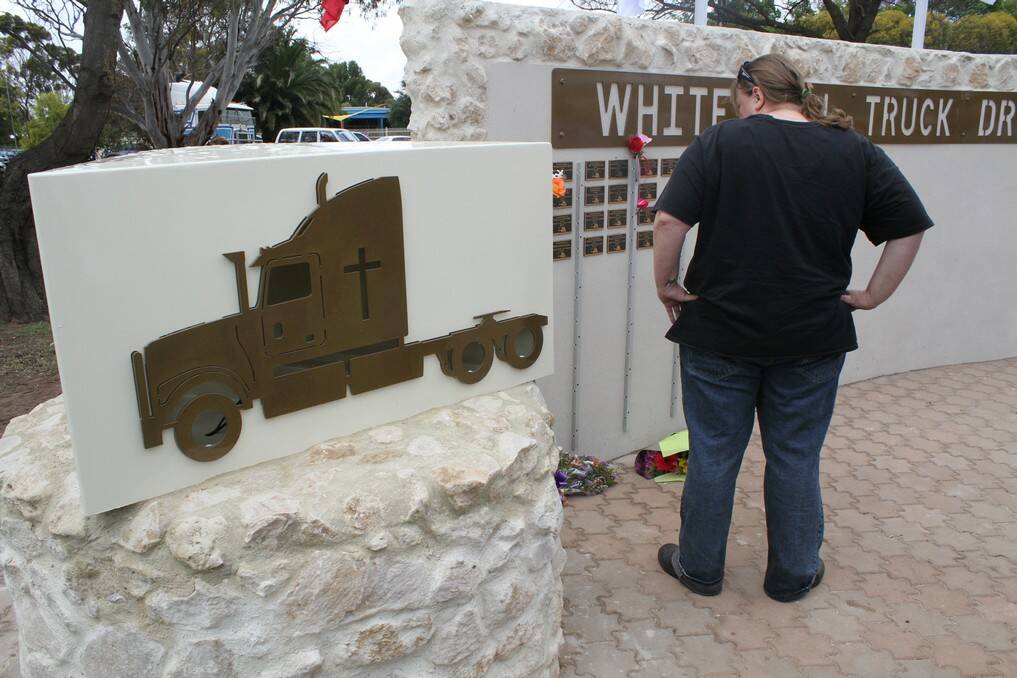 Inspecting the plaques on the wall at the White Hill Truck Drivers Memorial at Murray Bridge during the opening. 