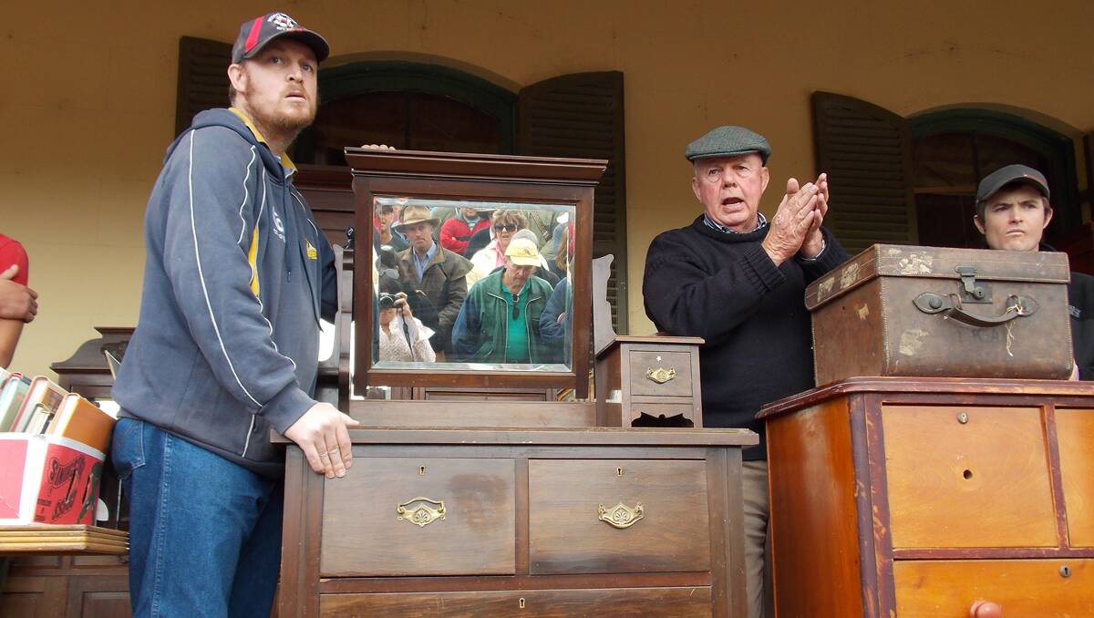 Trenton Lee and auctioneer Stewart Lee  during the  clearing sale at Cambalong. Despite chilly conditions,  and the sale  co-inciding with Bombala’s Australia Day celebrations, there was a good turnout of  350-400 people. Only four lots were passed in.