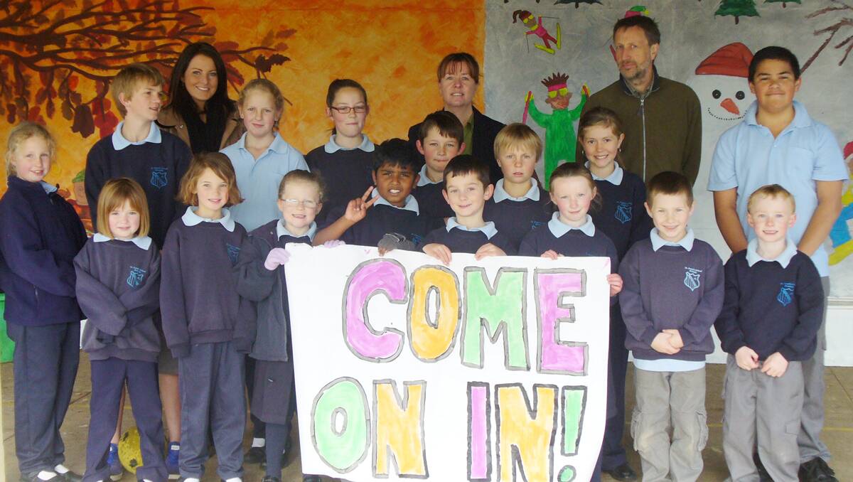 Thrilled that St Joseph’s Primary School has escaped closure are staff members, Alice Reardon, Kim Crannis and Matthew Farran with students, (back) Callum Bedingfield, Katie Farrell, Tayla Ventry, Jack Ventry, Jasper Bruce, Jade Brotherton, BJ Gaunson-Papalii, (front) Jaimie Farrell, Jemima Merritt, Lucy Merritt, Brylie Stewart, Pawan Weragala, Max Chaplin, Lottie Telford, James Tellis and Tait McIntosh, who encourage all to visit during today’s Open Day.