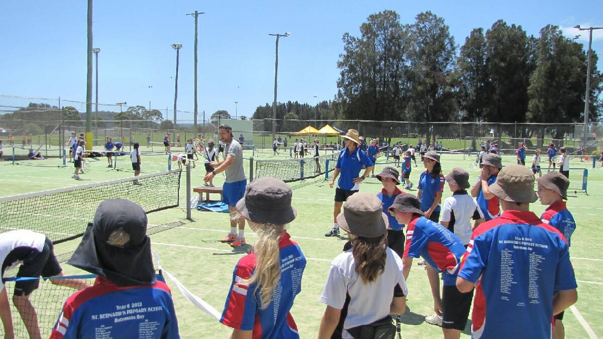  BATEMANS BAY: Troy Smith and Batemans   Bay tennis coach Rob Frawley teach the   art of the forehand to local students   at Tuesday's Australian Open Blitz.