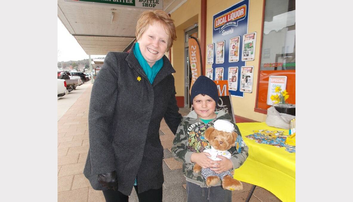 Amanda Radford of the Cancer Council with a very happy Cohen Jamieson who adopted a Daffodil Day Bear at the street stall in Bombala.
