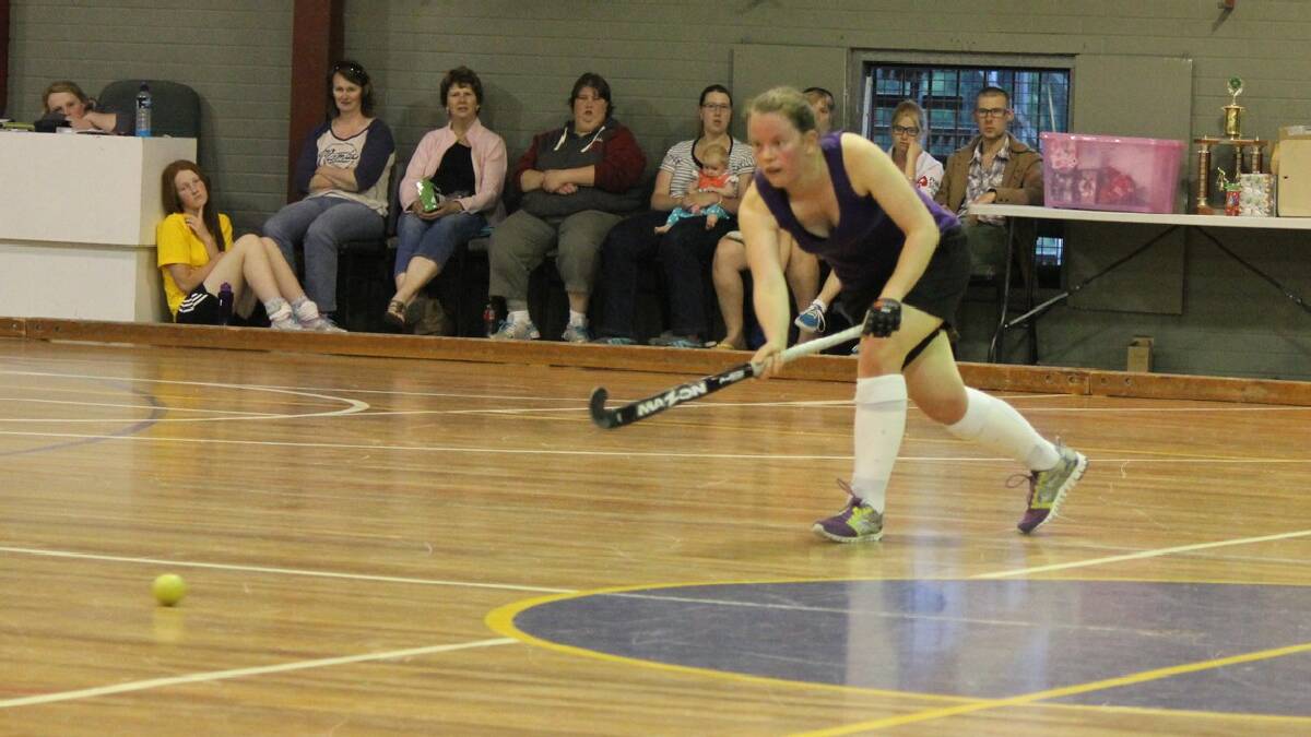 BEGA: Alana Koellner slaps the puck across to a team-mate during the Bega Indoor Hockey grand finals on Sunday. 