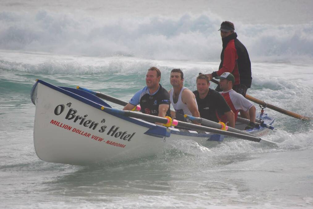 NAROOMA: The Narooma Surf Life Saving Club George Bass Surfboat Marathon rowers ride a wave back in after another grueling   training run earlier this month. Pictured are Adam Morris, Rod Patmore, Johnny Davis, Jae Constable and sweep Brendan   Constable. Photo by Fleur Constable