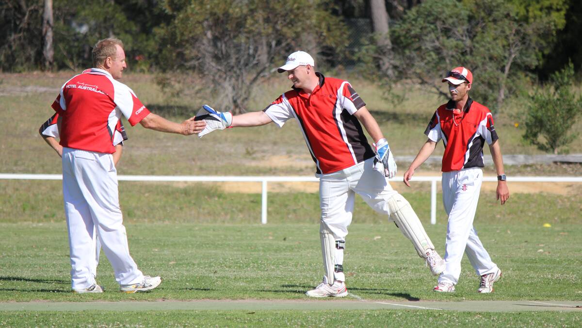 EDEN: Neil Baker (left) gives a quick high five to wicket keeper Ian Smith after catching the first wicket on Saturday. 