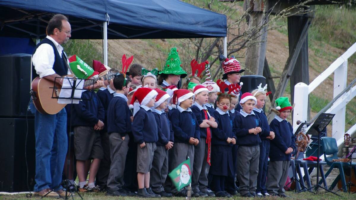 BOMBALA: Christmas hit Bombala this week with Carols by Candlelight at the railway, with Paul Bennett leading the St Joseph’s Primary School Choir in “Rudolph”.