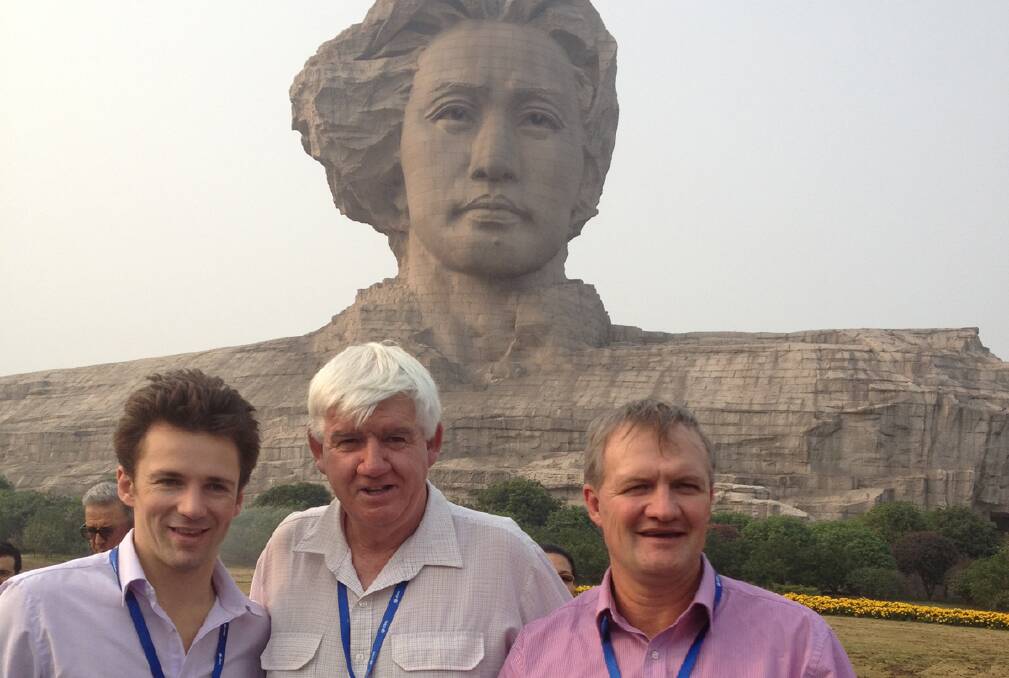 Cr Bob Stewart (centre) with Hugh Kater and Dean Lynch near a Chairman Mao sculpture.