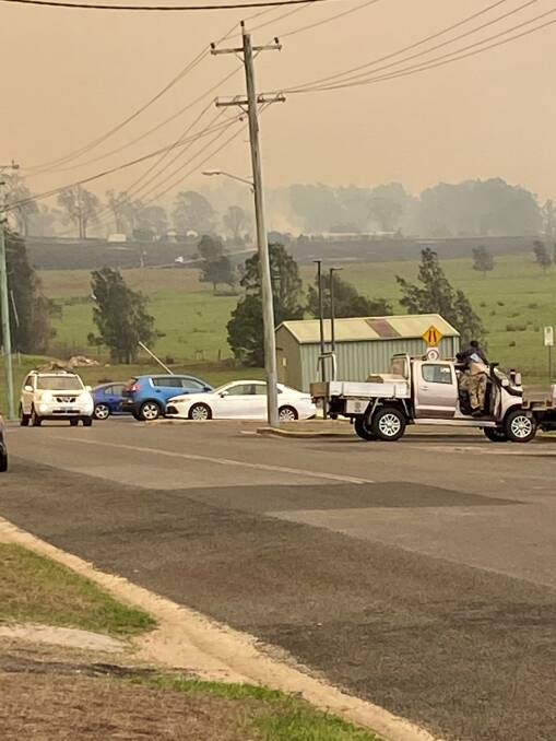 Dr Michael Holland's picture of a grass fire being brought under control near Moruya Hospital on the afternoon of Thursday, January 23.
