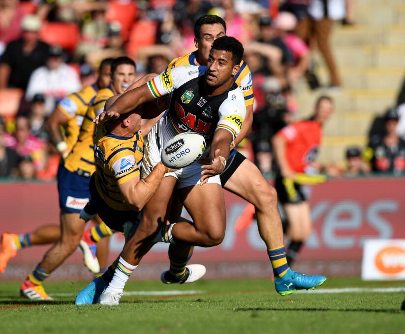 Quick pass: Penrith Panther Viliame Kikau gets a cheeky pass away during a clash with the Parramatta Eels with the two clubs to visit Bega in February. Picture: NRL. 