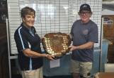 President of last year's Grudge Match winner Pambula Fishing Club Joe Klimas passes on the trophies to the 2024 winner Eden Amateur Fishing club president Val Cartledge. Picture supplied