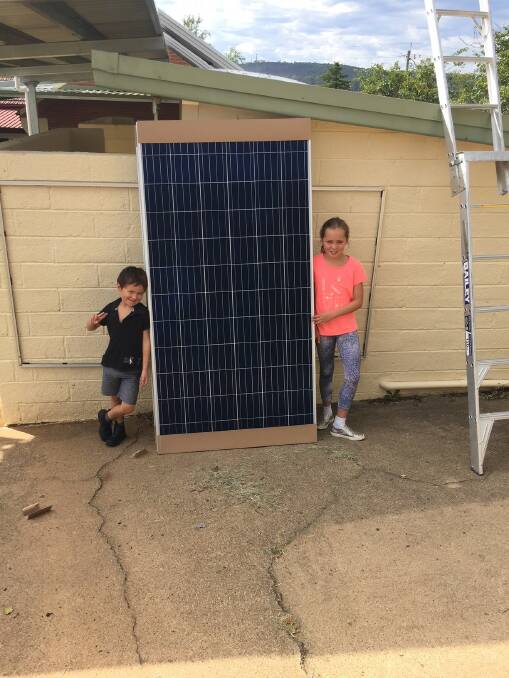 St Joseph's pupils Lucas and Mabel Tucker inspect the solar panels that were installed at the school over the summer holidays.