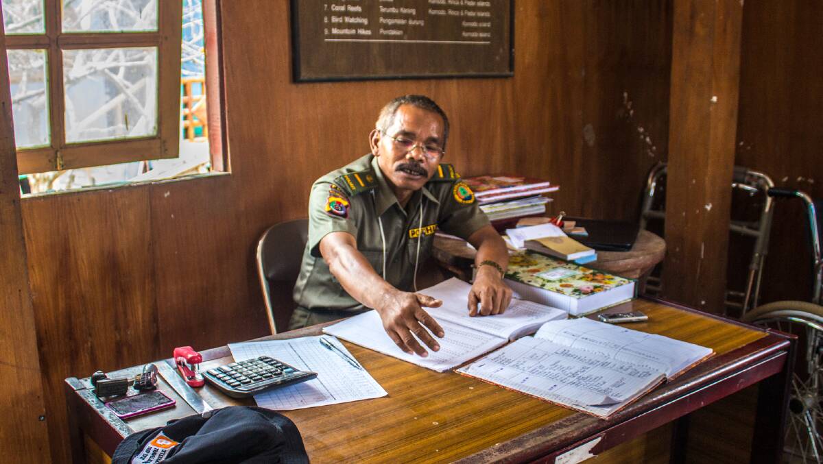 Maen at his desk where he was attacked by a Komodo dragon in 2009. Picture: Michael Turtle