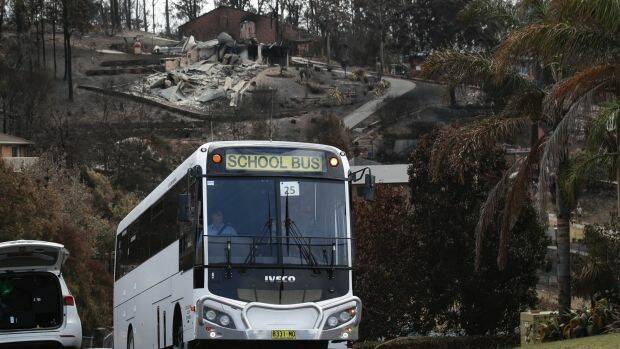 A bus ferrying Tathra residents takes them on a tour of the fire-affected town. Photo: Alex Ellinghausen
