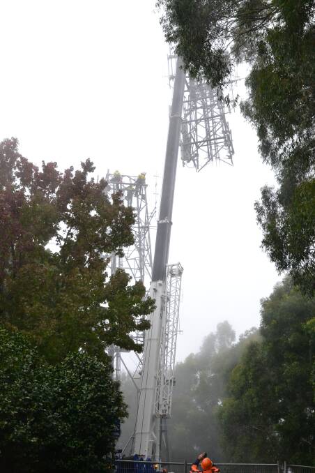 The first section of the old telecommunications tower from Cambewarra Mountain is removed.