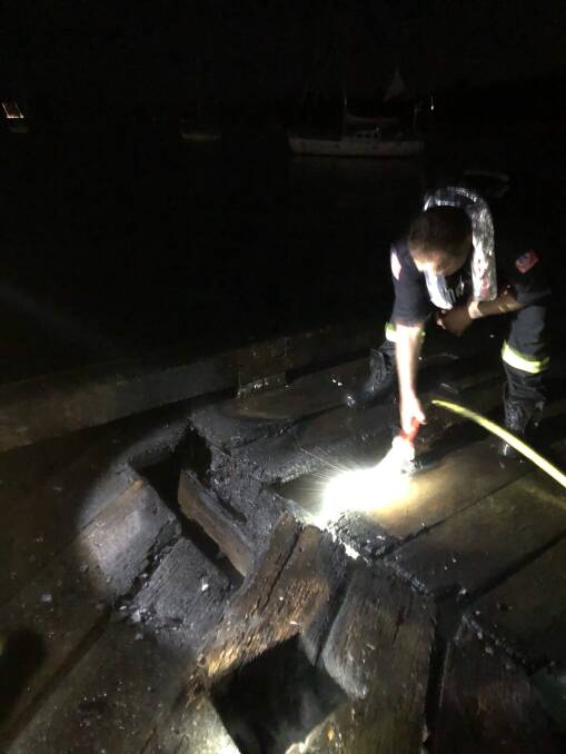Wharf damaged: Eden Fire and Rescue crews extinguish a fire on Eden's Cannery Wharf on Saturday night. Picture: Eden Fire and Rescue. 