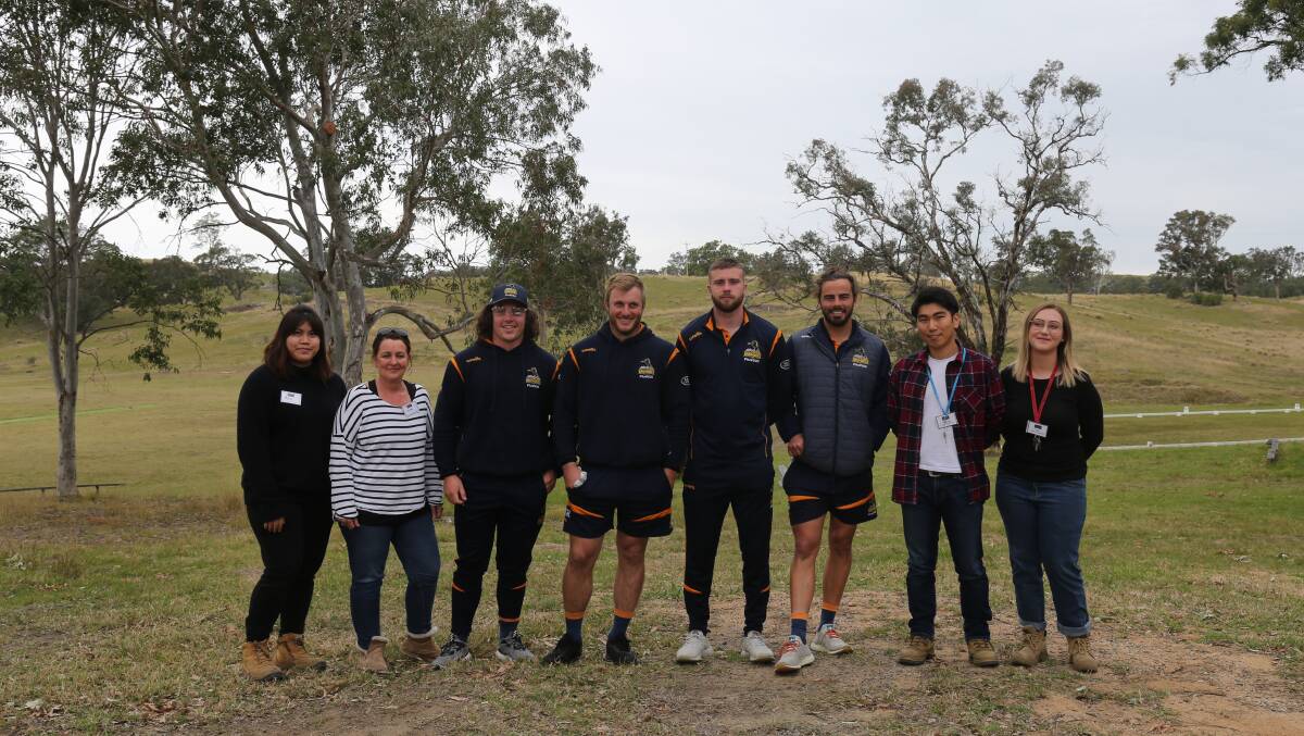 ACT Brumbies players catch up with some of BlazeAid Bemboka volunteers during their visit on Wednesday. 