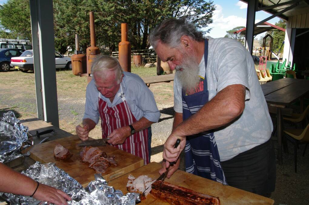 Barry Manning and Bob Walder prepare dinner for the crowd at the 33rd annual Cathcart Variety concert.