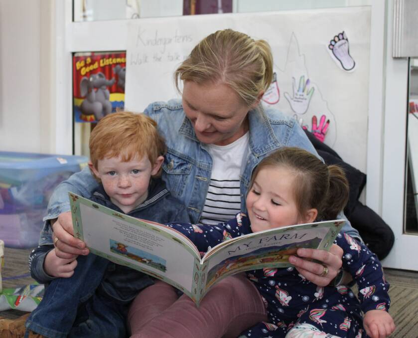 EDUCATION SPICE: Cooper and Rebel Browlie having fun reading a book with Paige Kimber participating in the SPICE group at St. Joseph's Primary School on Friday.