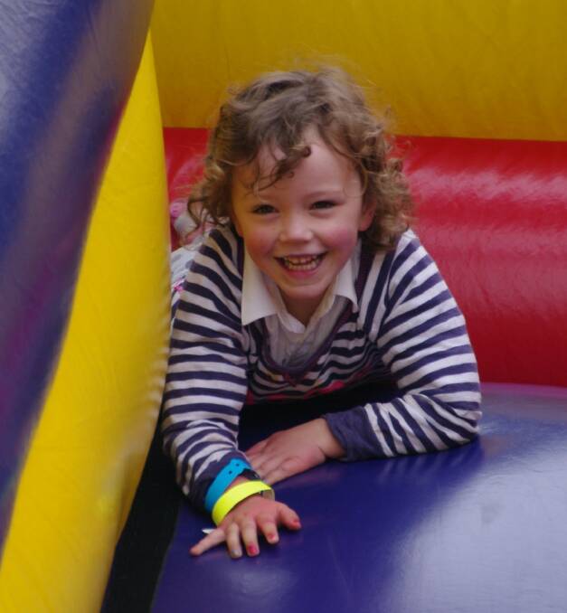 Little Asha Walder having heaps of fun on the jumping castle at the Bombala Show on Saturday.